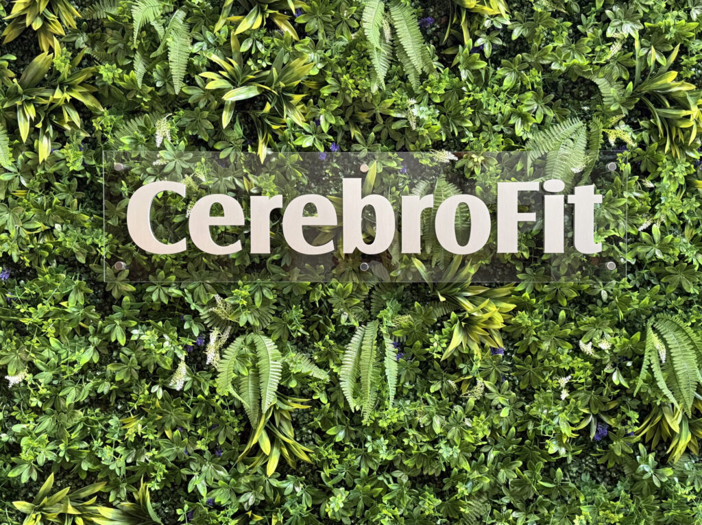 CerebroFit text overlaying an image of a living wall.
