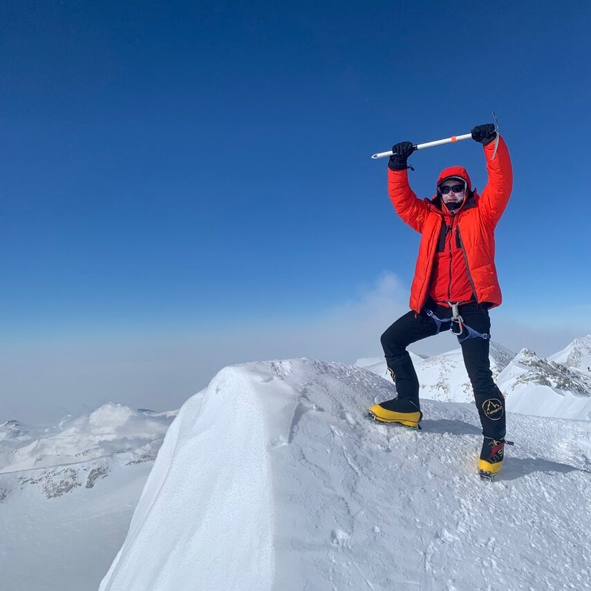 John Horgan standing on top of an arctic mountain peak.